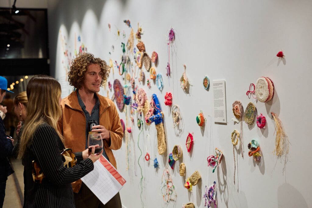 Visitors exploring FORM Gallery artworks from the 'Woven together' exhibition