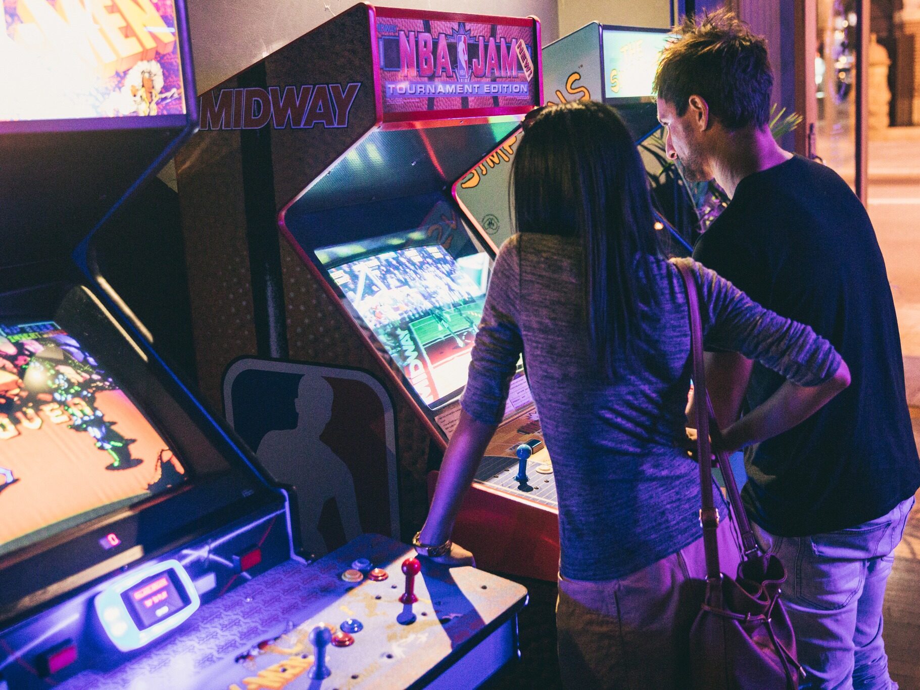 People enjoying classic arcade games at Palace Arcade after the footy
