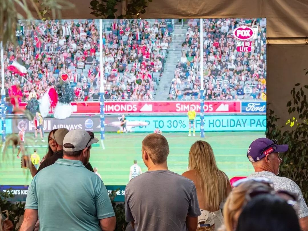 Footy fans watching the big game on the large screen at Broken Hill Hotel