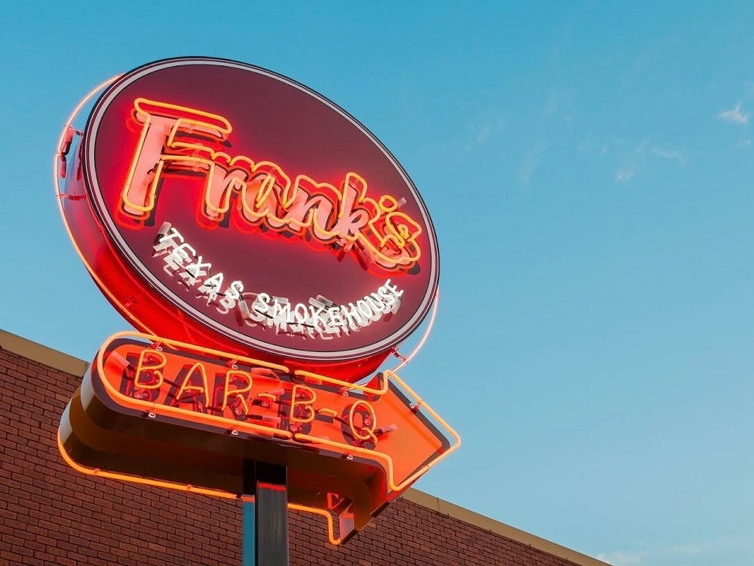 The neon sign outside Frank's BBQ, welcoming fans for a hearty post-footy meal
