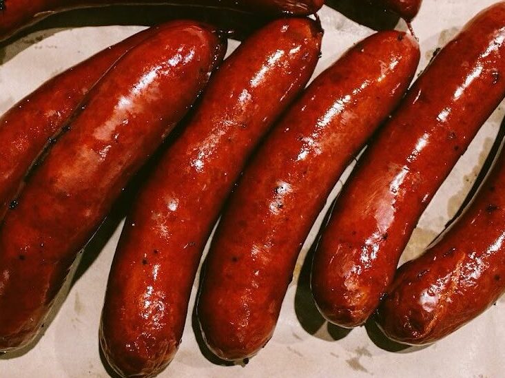 Juicy sausages sizzling at Frank's BBQ, a favourite choice for BBQ enthusiasts
