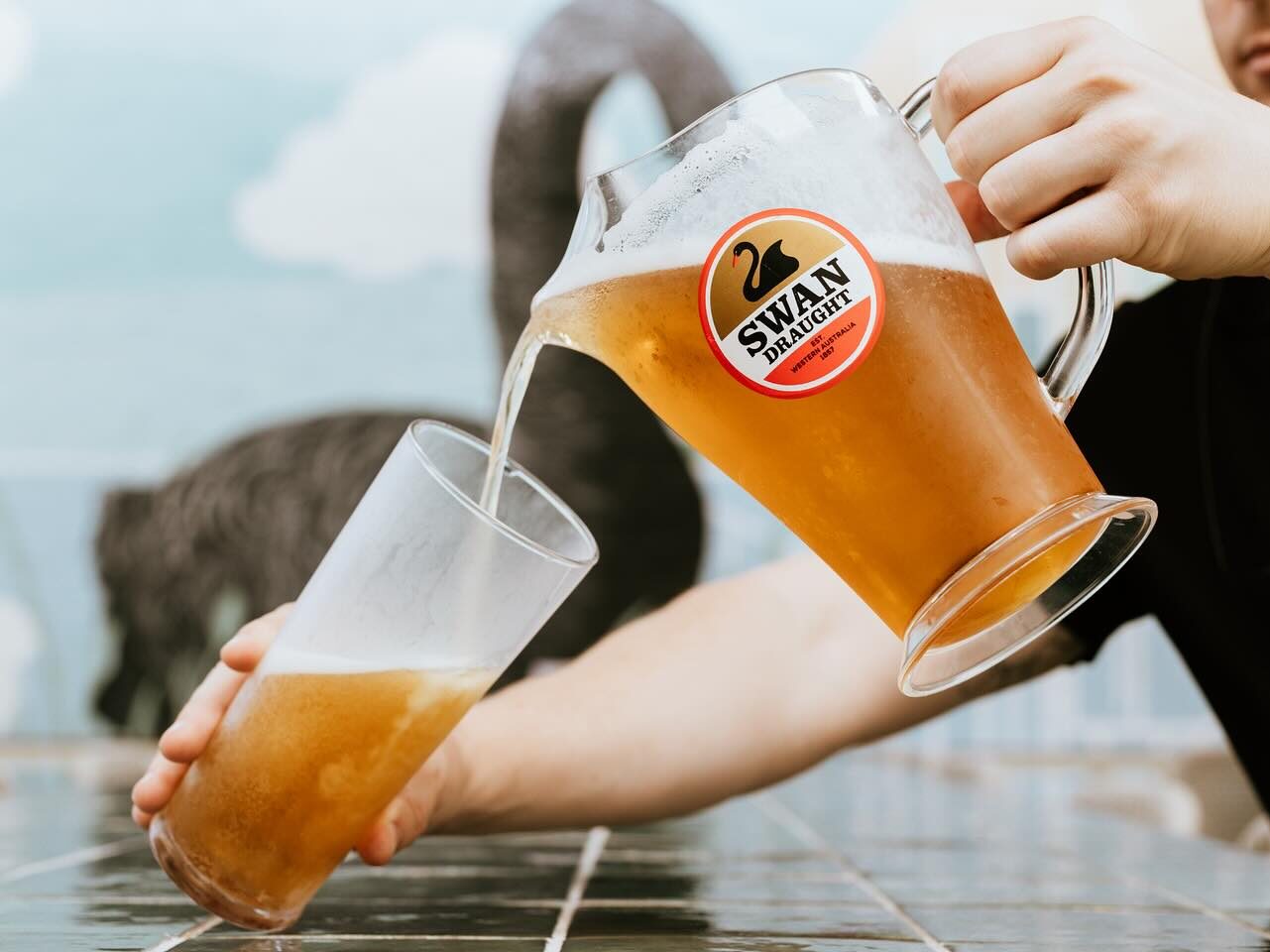 A refreshing beer being poured at Vic Park Hotel, a go-to spot for footy fans.