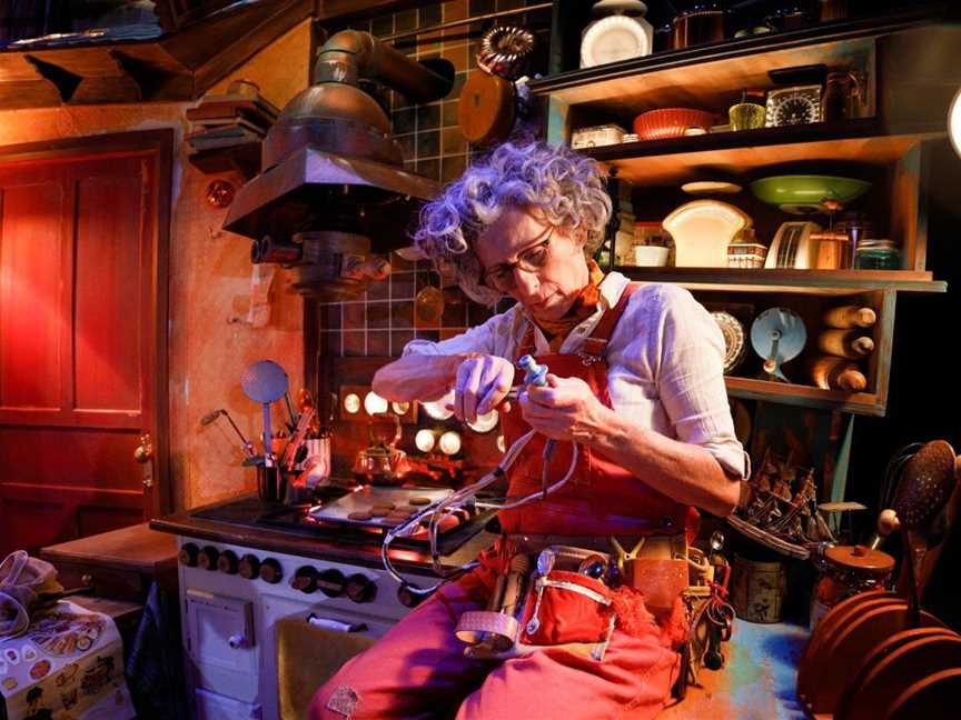 Scene from the theatre production HOUSE featuring a close up of women fiddling with a wire