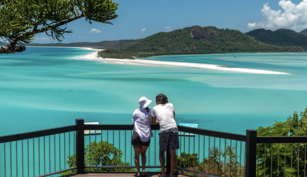 Couple enjoying to views above the turquoise Whitsundays beaches